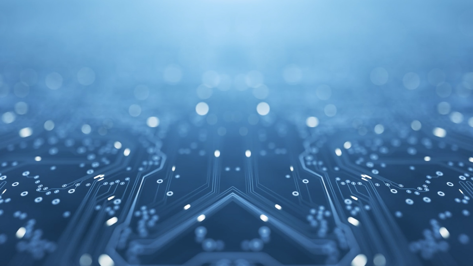 Close-up view of a circuit board with a focus on the intricate pattern of electronic circuits and connectors, creating a technological backdrop. The overall color tone is a cool blue, conveying a sense of advanced digital technology.